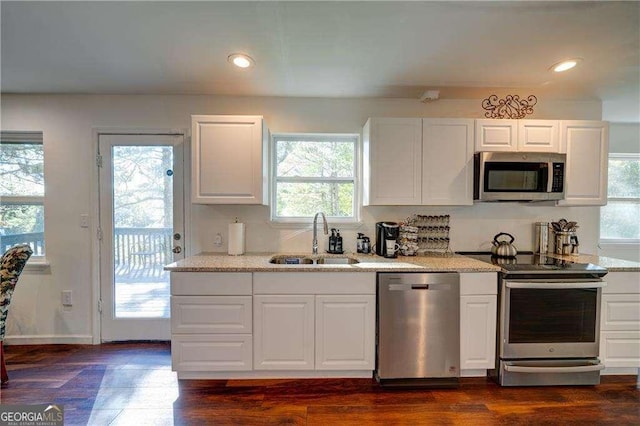 77 Hunters Grn, Dallas, GA 30157 - kitchen with dark wood finished floors, light stone counters, appliances with stainless steel finishes, white cabinets, and a sink