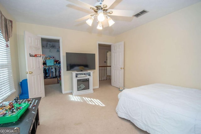 207 Lakeshore Way, Lagrange, GA 30240 - bedroom featuring a walk in closet, light carpet, multiple windows, and a closet