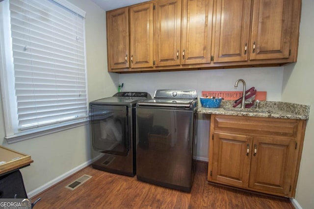 207 Lakeshore Way, Lagrange, GA 30240 - laundry room featuring dark wood-type flooring, washer and clothes dryer, and cabinet space