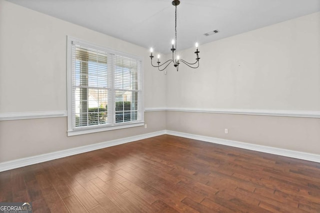 675 Timber Ives Dr, Dacula, GA 30019 - unfurnished dining area featuring a chandelier, wood finished floors, and baseboards