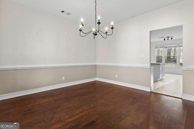 675 Timber Ives Dr, Dacula, GA 30019 - unfurnished room with hardwood / wood-style flooring, a chandelier, and baseboards