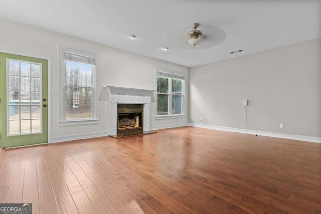 675 Timber Ives Dr, Dacula, GA 30019 - unfurnished living room with wood finished floors, a ceiling fan, a fireplace, and baseboards