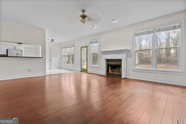 675 Timber Ives Dr, Dacula, GA 30019 - unfurnished living room featuring wood finished floors, a premium fireplace, and baseboards