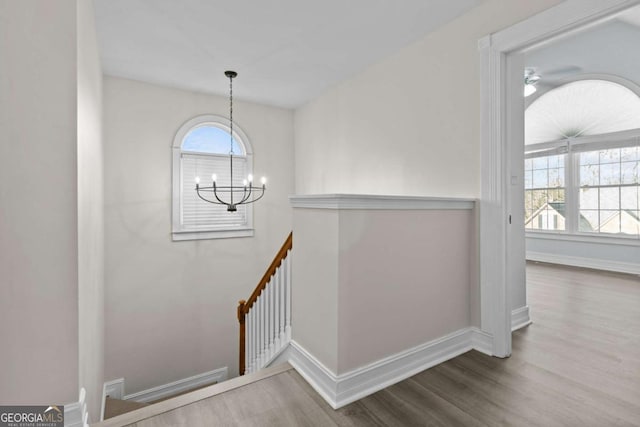 675 Timber Ives Dr, Dacula, GA 30019 - staircase with a chandelier, wood finished floors, baseboards, and a ceiling fan