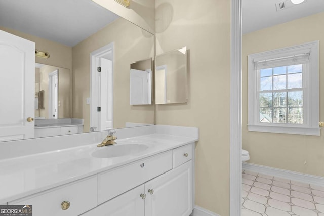 675 Timber Ives Dr, Dacula, GA 30019 - bathroom with vanity, toilet, and baseboards