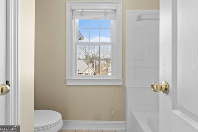 675 Timber Ives Dr, Dacula, GA 30019 - bathroom with toilet, baseboards, and shower / tub combination