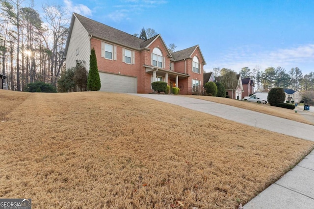 675 Timber Ives Dr, Dacula, GA 30019 - traditional-style home featuring concrete driveway, a garage, brick siding, and a front yard