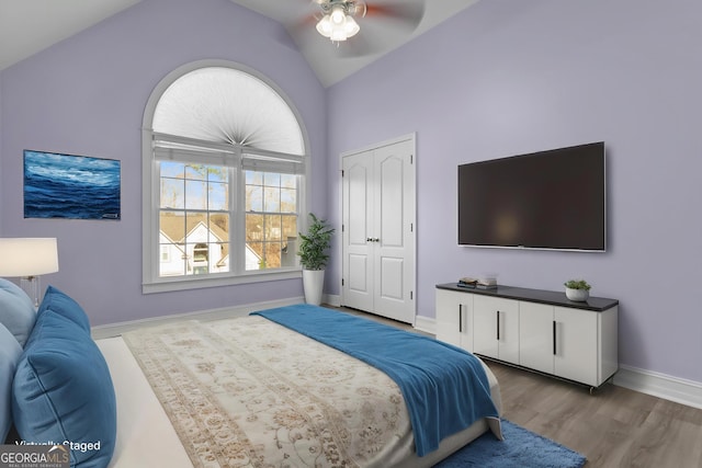 675 Timber Ives Dr, Dacula, GA 30019 - bedroom featuring wood finished floors, baseboards, high vaulted ceiling, a ceiling fan, and a closet