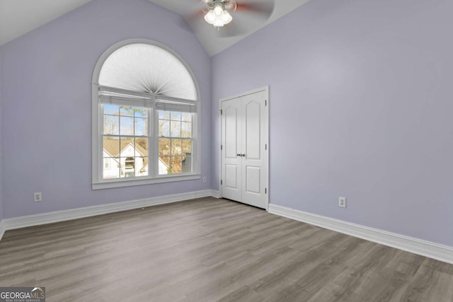 675 Timber Ives Dr, Dacula, GA 30019 - empty room with a ceiling fan, wood finished floors, lofted ceiling, and baseboards