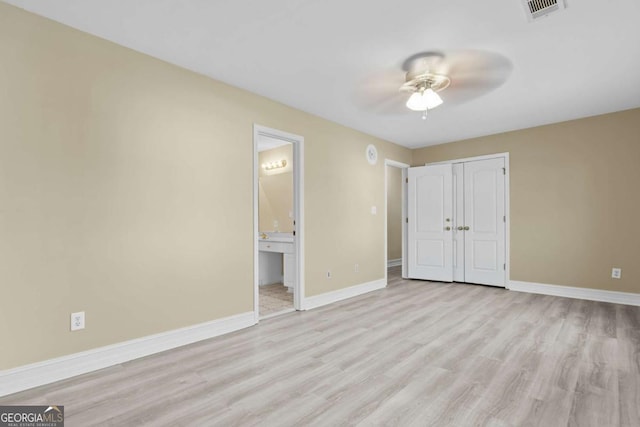 675 Timber Ives Dr, Dacula, GA 30019 - unfurnished bedroom featuring light wood-type flooring, baseboards, ensuite bathroom, a closet, and a ceiling fan