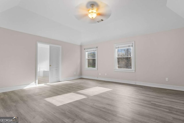 675 Timber Ives Dr, Dacula, GA 30019 - empty room featuring a ceiling fan, vaulted ceiling, wood finished floors, and baseboards