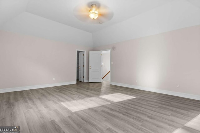 675 Timber Ives Dr, Dacula, GA 30019 - empty room with a ceiling fan, lofted ceiling, wood finished floors, and baseboards