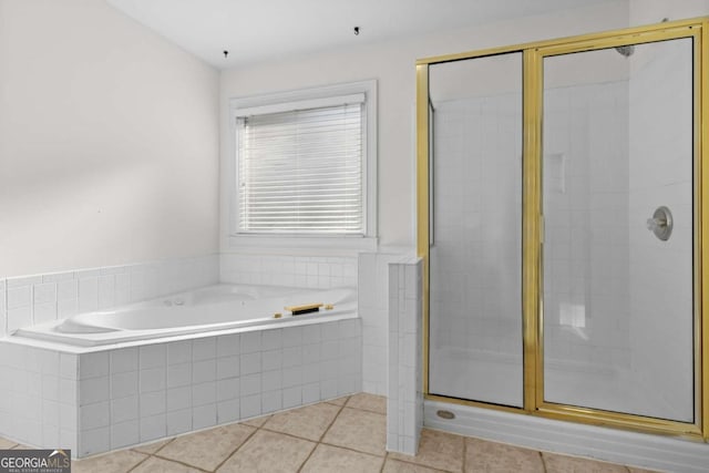 675 Timber Ives Dr, Dacula, GA 30019 - bathroom featuring a stall shower, a bath, and tile patterned flooring