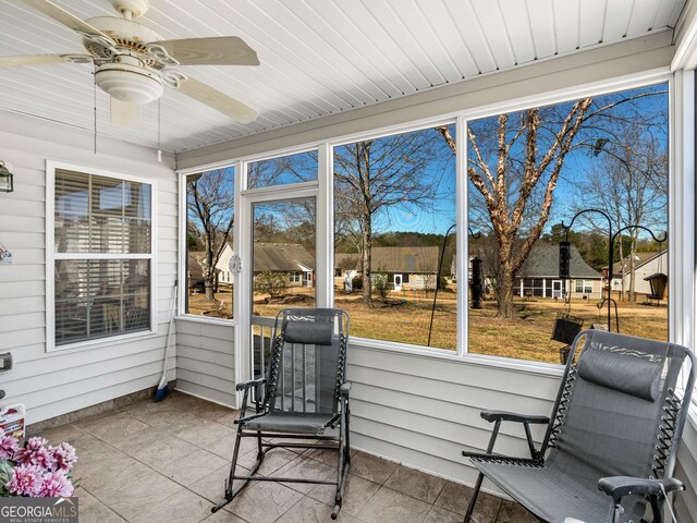 sunroom / solarium with a wealth of natural light and a ceiling fan