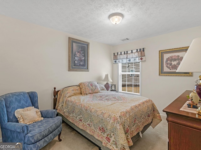 carpeted bedroom with visible vents and a textured ceiling