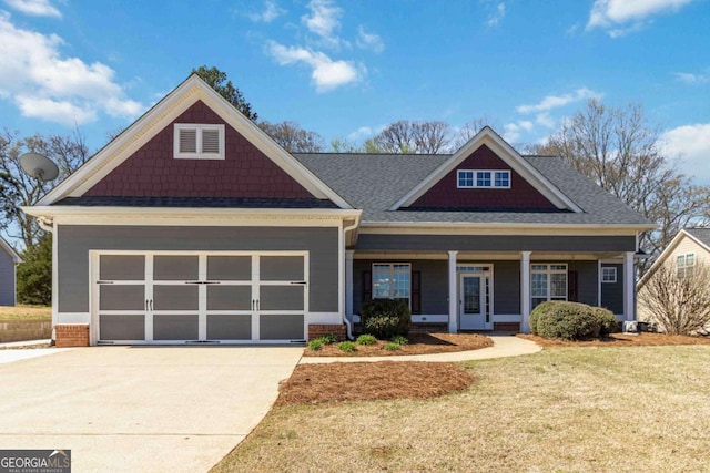craftsman inspired home featuring an attached garage, brick siding, a porch, a front yard, and driveway