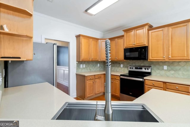 kitchen featuring backsplash, visible vents, crown molding, appliances with stainless steel finishes, and a sink
