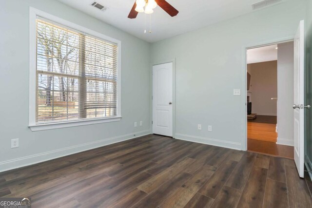 unfurnished room featuring plenty of natural light, light colored carpet, and visible vents