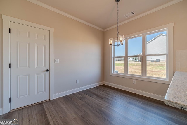 unfurnished dining area featuring a chandelier, dark wood-style floors, crown molding, and baseboards
