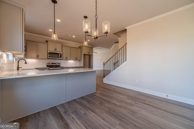 kitchen with stainless steel appliances, a sink, ornamental molding, baseboards, and light stone counters