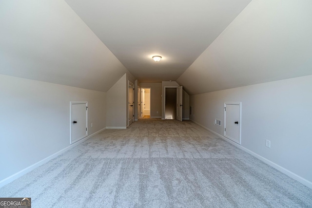 bonus room with carpet flooring, vaulted ceiling, and baseboards