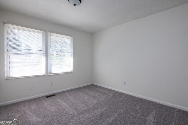6136 Marbut Rd, Lithonia, GA 30058 - carpeted spare room featuring healthy amount of natural light and baseboards