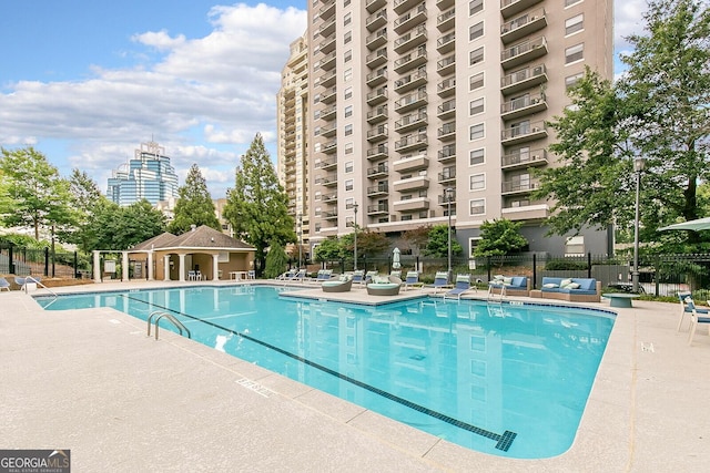 pool featuring a patio area and fence