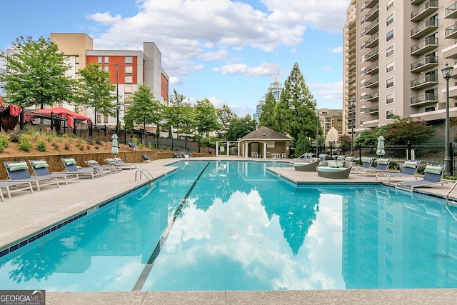 pool featuring a patio area and fence