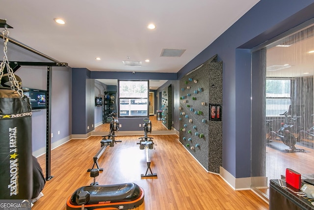 exercise area featuring recessed lighting, baseboards, and wood finished floors