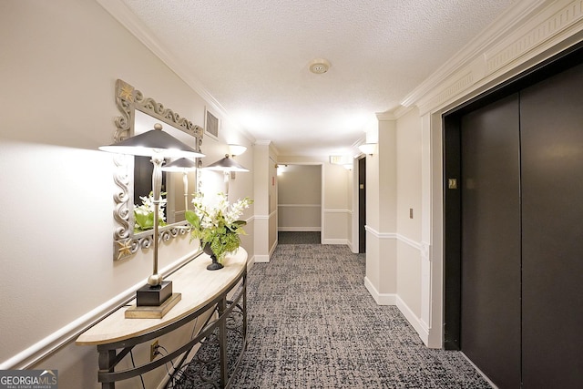 hall with a textured ceiling, carpet flooring, ornamental molding, and elevator