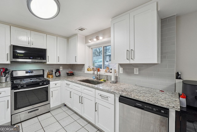 1291 Marcelle Heights Pl, Norcross, GA 30093 - kitchen with stainless steel appliances, a sink, decorative backsplash, and white cabinetry