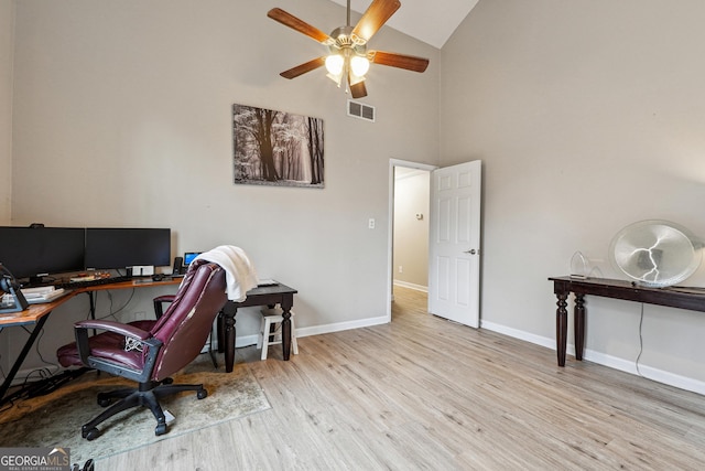 office area with high vaulted ceiling, a ceiling fan, wood finished floors, baseboards, and visible vents