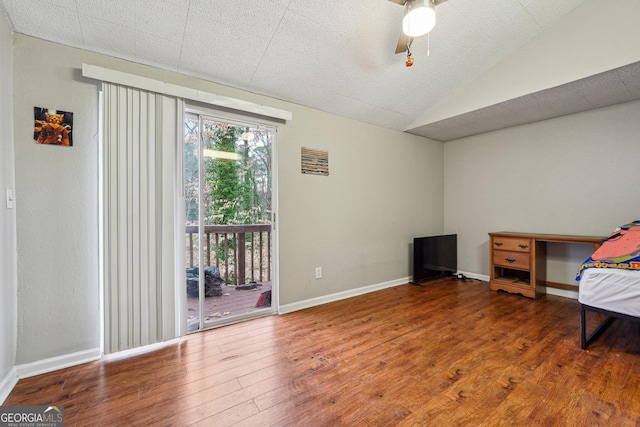 1291 Marcelle Heights Pl, Norcross, GA 30093 - unfurnished bedroom with access to outside, wood finished floors, vaulted ceiling, ceiling fan, and baseboards