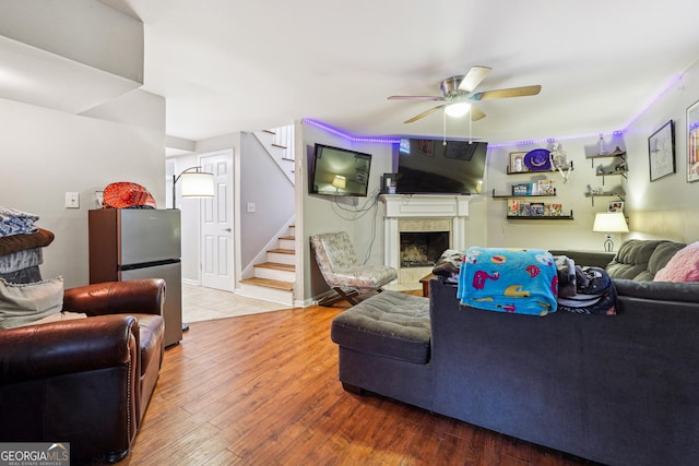 1291 Marcelle Heights Pl, Norcross, GA 30093 - living area featuring a ceiling fan, stairs, a fireplace, and hardwood / wood-style floors