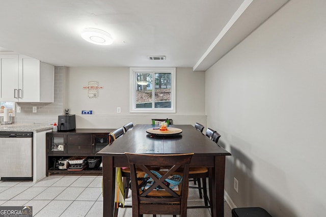dining area featuring visible vents and light tile patterned floors