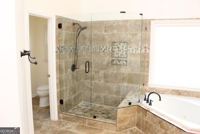 bathroom with a bath, a shower stall, and toilet