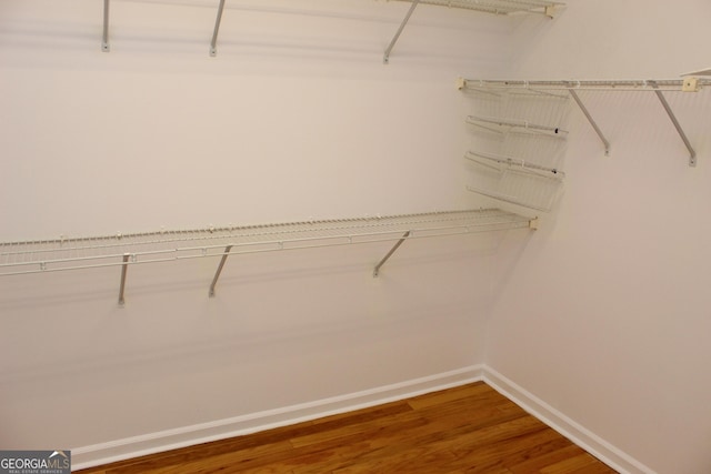 spacious closet with wood finished floors