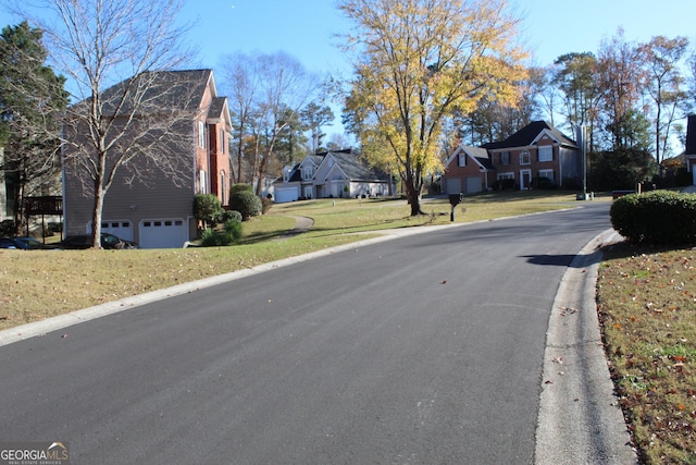 view of street featuring a residential view and curbs