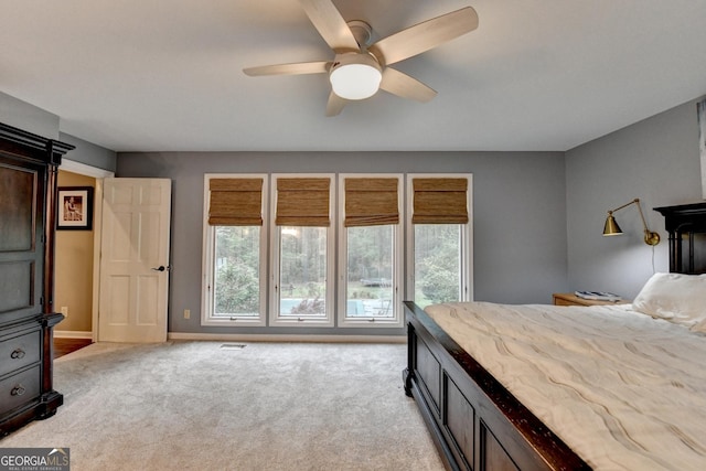 bedroom with light colored carpet, baseboards, a ceiling fan, and visible vents