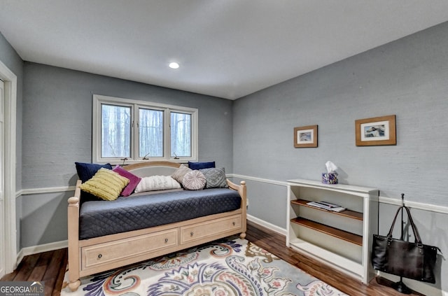 bedroom featuring baseboards and wood finished floors