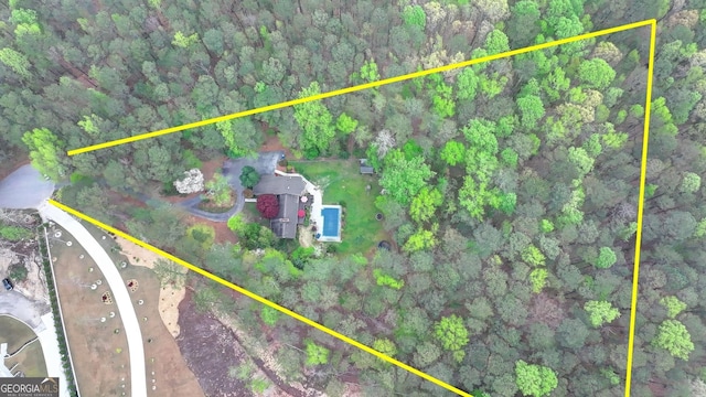 drone / aerial view featuring a view of trees