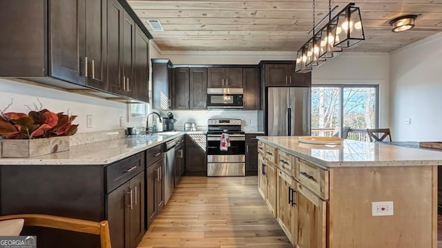 360 Prince Dr, Morganton, GA 30560 - kitchen featuring light wood finished floors, appliances with stainless steel finishes, light stone countertops, and a sink
