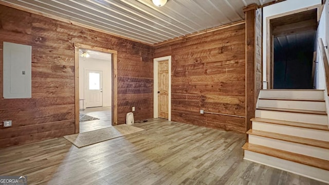 360 Prince Dr, Morganton, GA 30560 - spare room featuring electric panel, wood walls, stairs, and wood finished floors