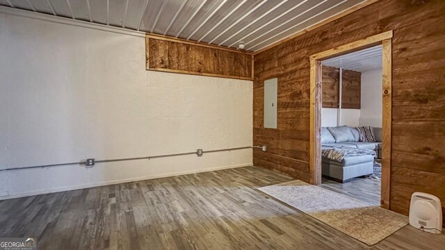 360 Prince Dr, Morganton, GA 30560 - empty room featuring electric panel, wooden walls, and wood finished floors