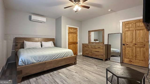 360 Prince Dr, Morganton, GA 30560 - bedroom with a ceiling fan, light wood-style floors, baseboards, and a wall mounted air conditioner