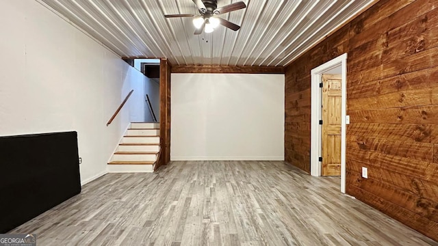 360 Prince Dr, Morganton, GA 30560 - unfurnished living room with wooden walls, stairway, ceiling fan, and wood finished floors