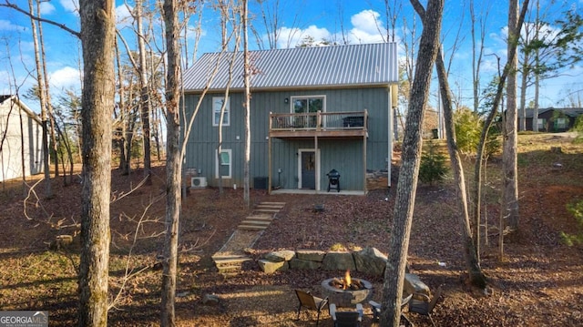 360 Prince Dr, Morganton, GA 30560 - rear view of property with metal roof, a fire pit, and a deck