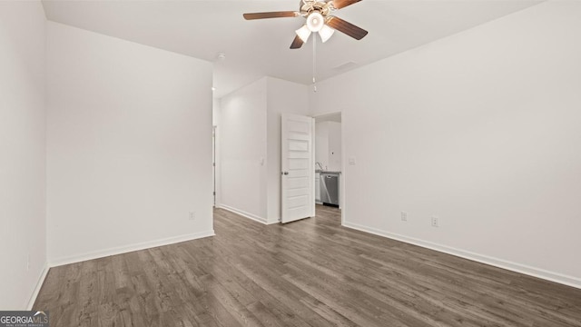 interior space with a ceiling fan, baseboards, and dark wood finished floors