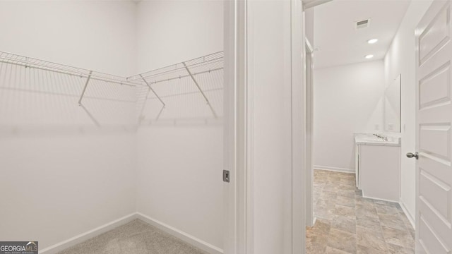walk in closet featuring visible vents