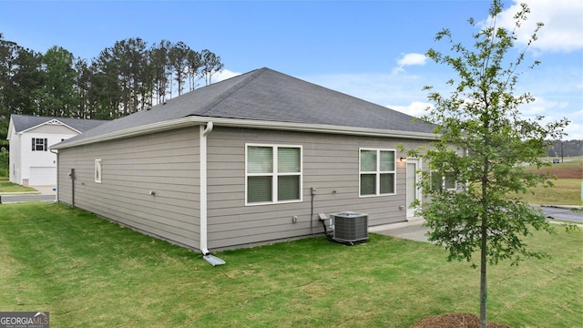 back of house with a yard, central air condition unit, and a patio